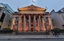 The six columns of the neo-classical Dome bar on Edinburgh's George Street are lit up in dramatic, soft orange and yellow lighting