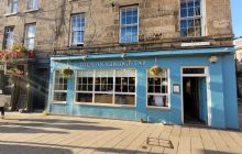 The turquoise frontage of the Stockbridge Tap pub on a sunny day in Spring