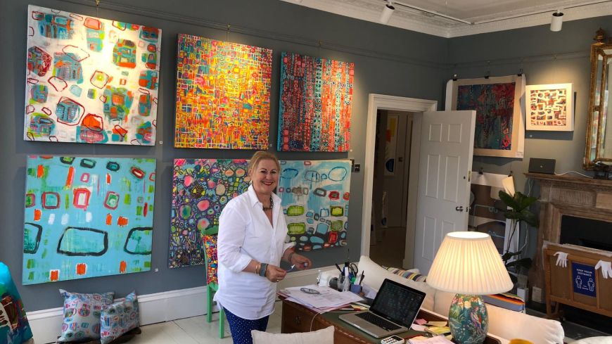 Julia Krone in her gallery - with art work from her Colour exhibition 