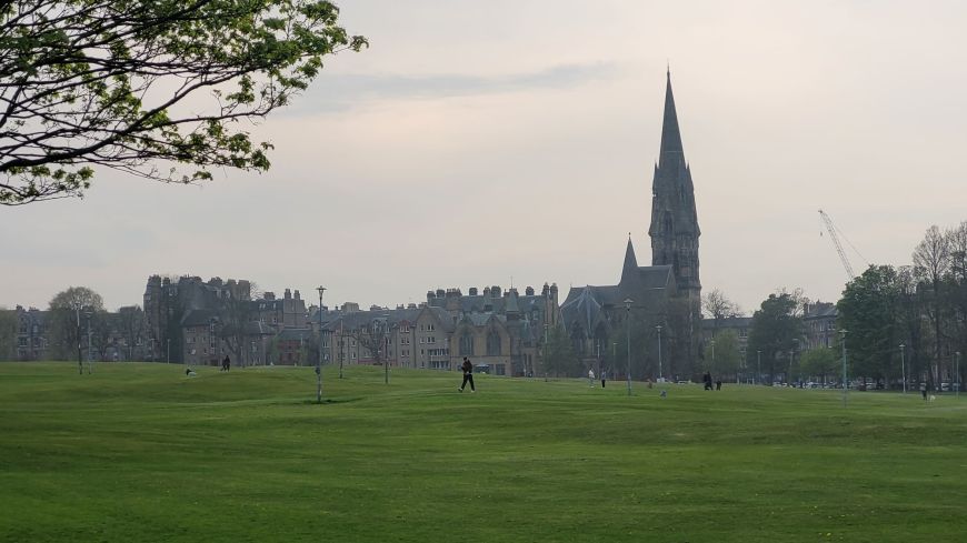 Dusk settles on Bruntsfield Links with the spire of Barclay Church rising high in the distance across the green