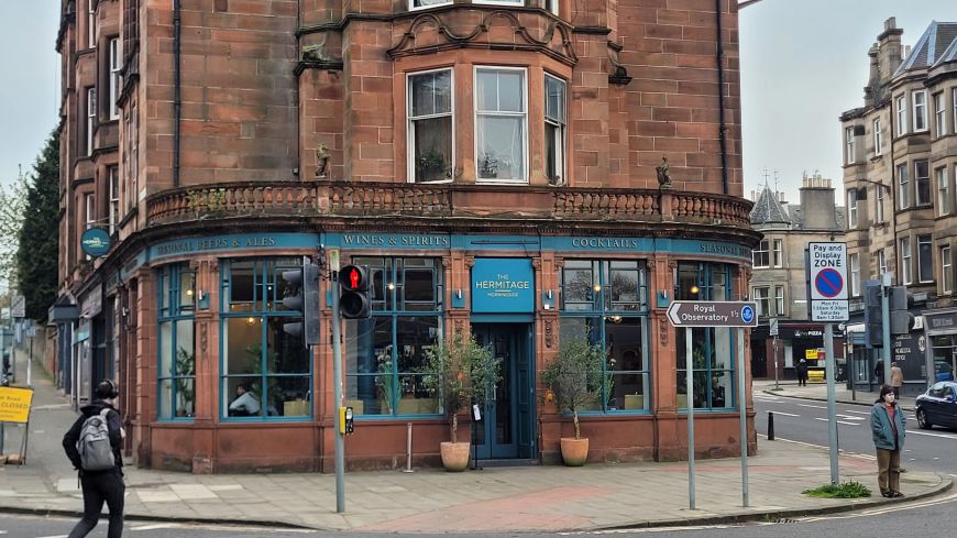 The red sandstone corner building of the Hermitage Bar in Morningside