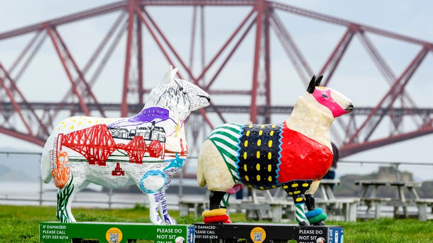 Two sheep sculptures in front of the Forth Rail Bridge