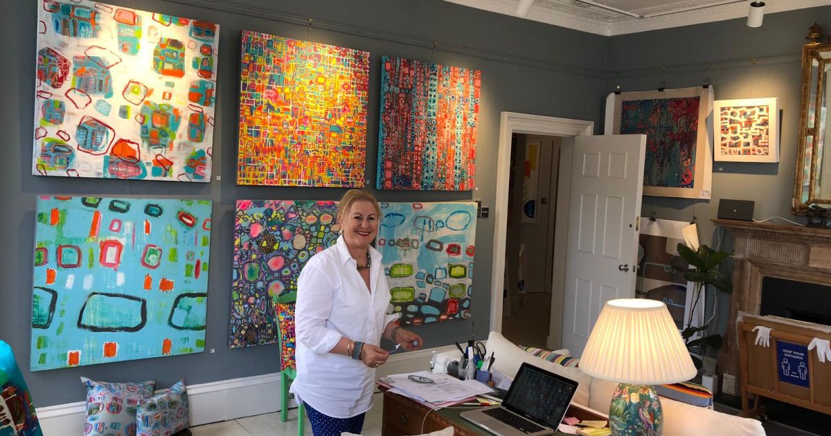 Julia Krone in her gallery - with art work from her Colour exhibition 