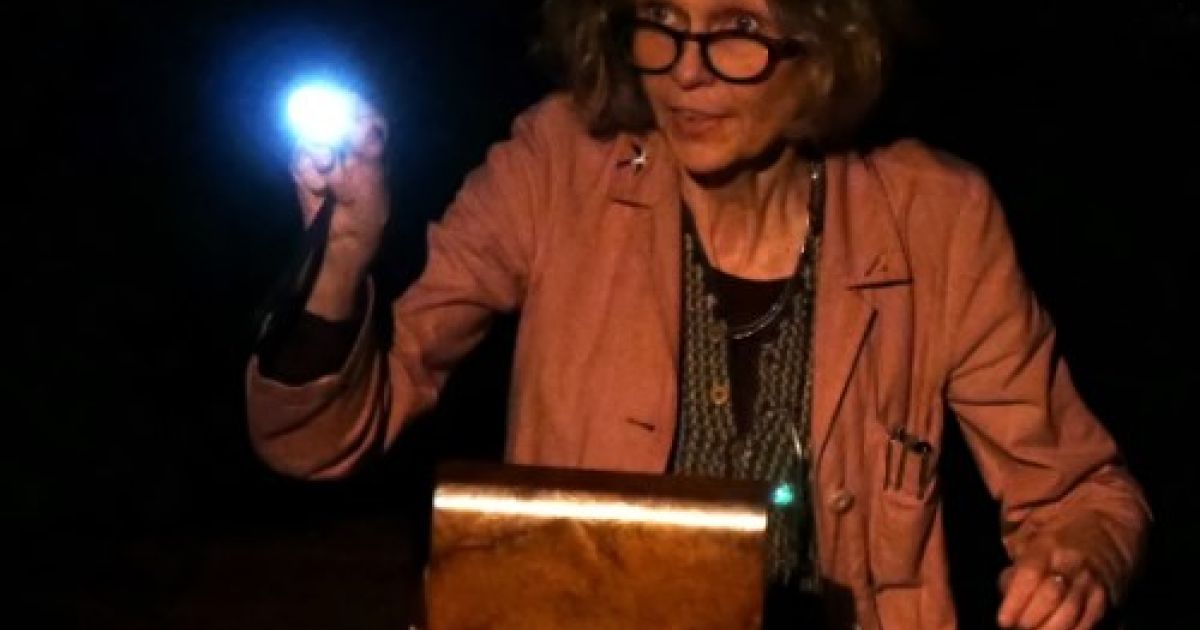 Maria MacDonell is pictured with a light, looking over the sewing box that contains Miss Lindsay's letters.