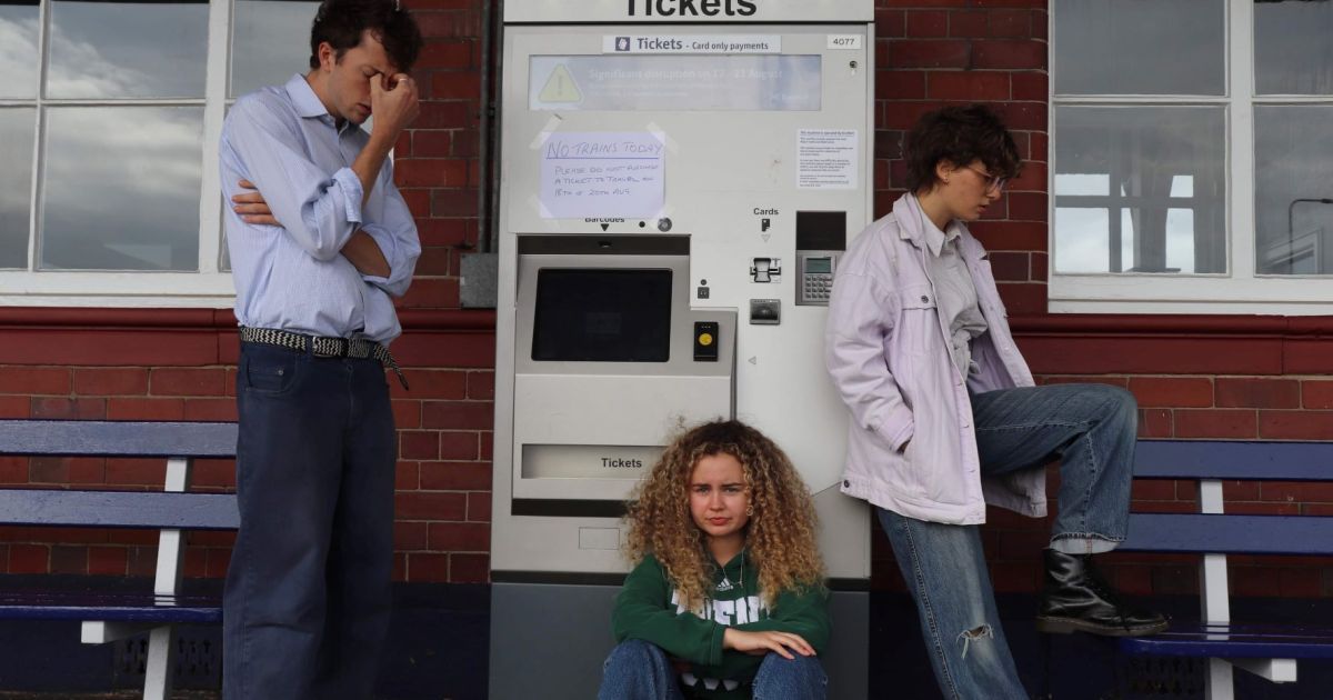 The cast at a railway station to dramatise a scene from No Time For Strangers 