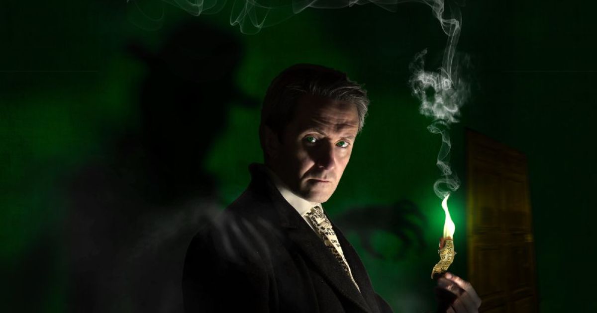Performer Noel Byrne looks moodily to the front, set in a dark atmsophere with a spooky feel