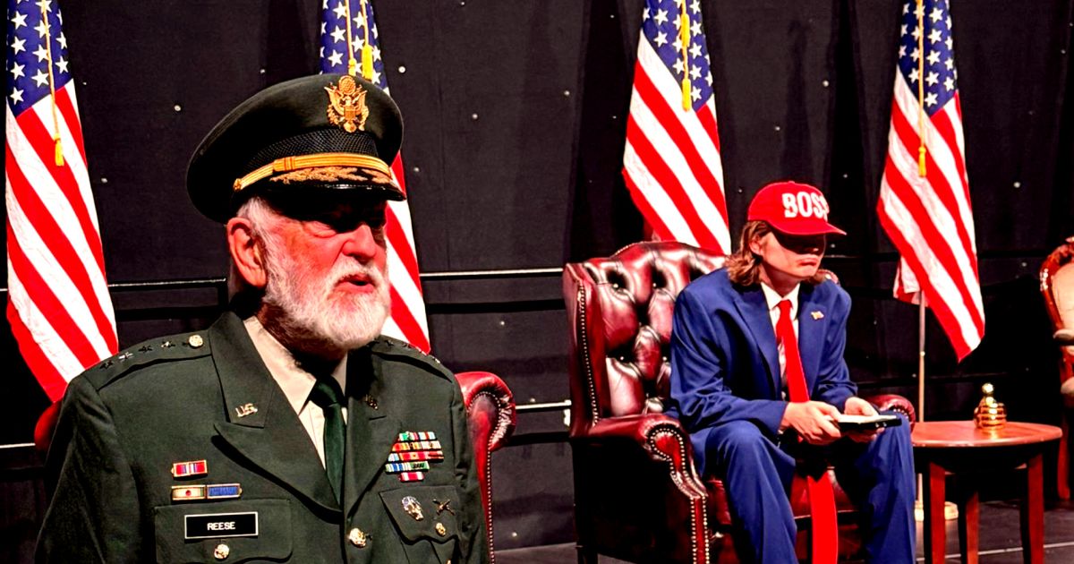 The General stands on the left, Trump is in the middle and several American flags surround the space.