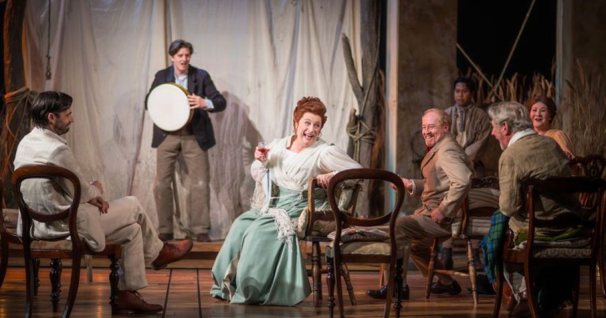 The Cast of The Seagull looking at each other jovially in the opening scene as they watch a performance